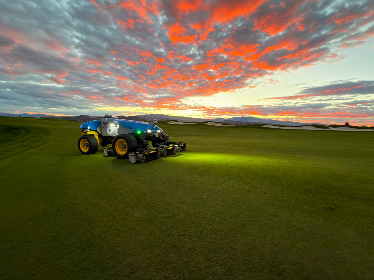 FireFly robotic fairway mower at Black Desert Resort at sunset