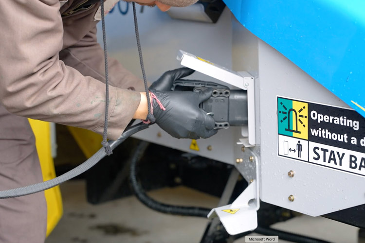 a person plugging in a robotic mower